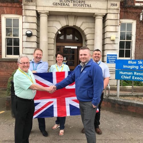 Volunteers with Flag outside Hospital