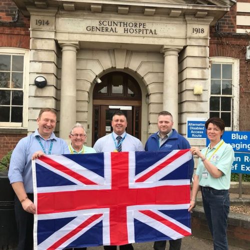 Volunteers with Flag outside Hospital