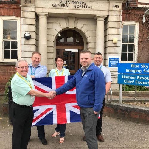 Volunteers with Flag outside Hospital