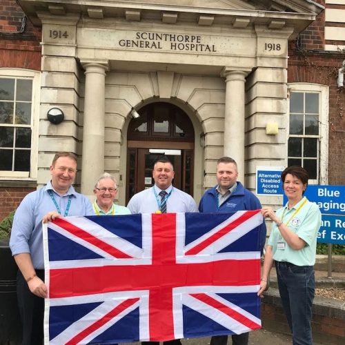 Volunteers with Flag outside Hospital
